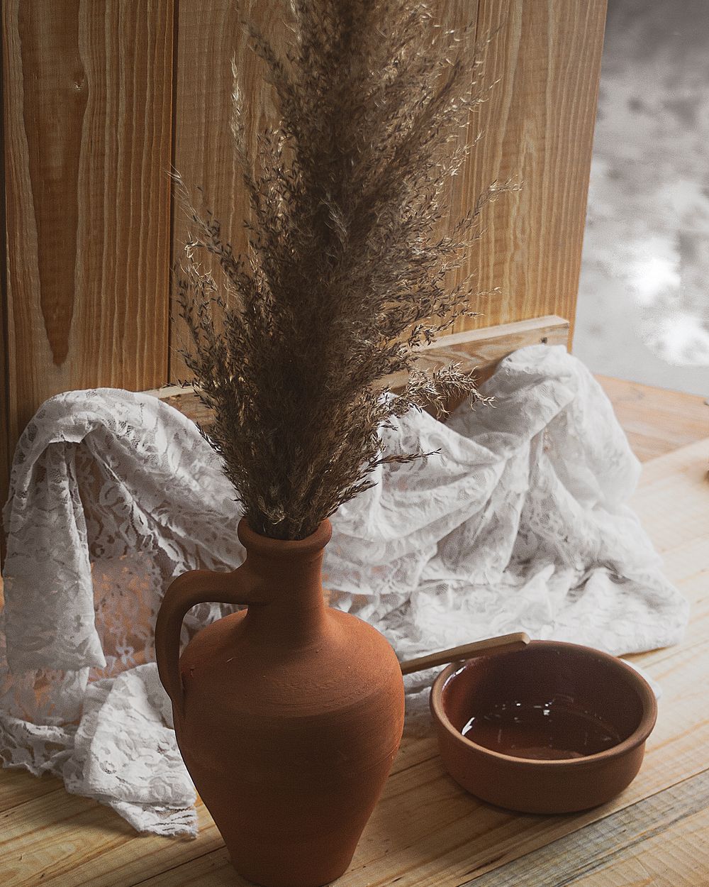 Vase with dried flowers and small bowl
