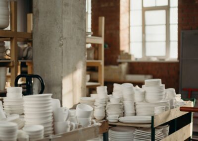 Handcrafted ceramic bowls and plates in a rustic workshop ambiance.